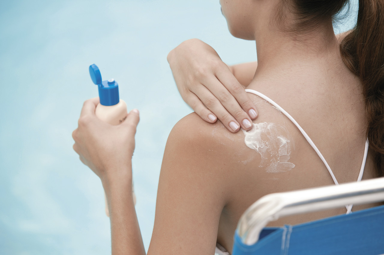 Woman Applying Sunscreen --- Image by © Royalty-Free/Corbis